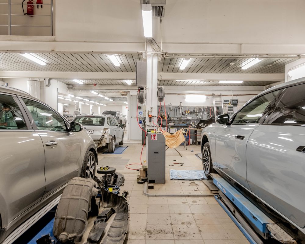 Cars undergoing maintenance inside an automotive repair shop